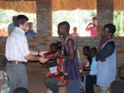 Members receive the Makhua New Testament during inauguration